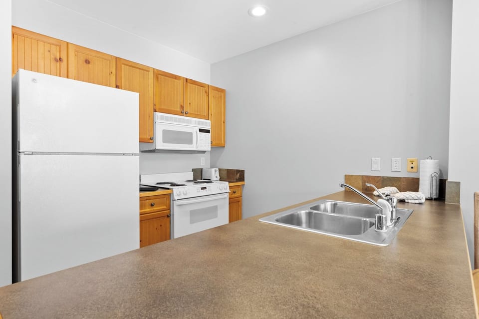 Private kitchen with all the essential appliances to make a home-cooked meal.