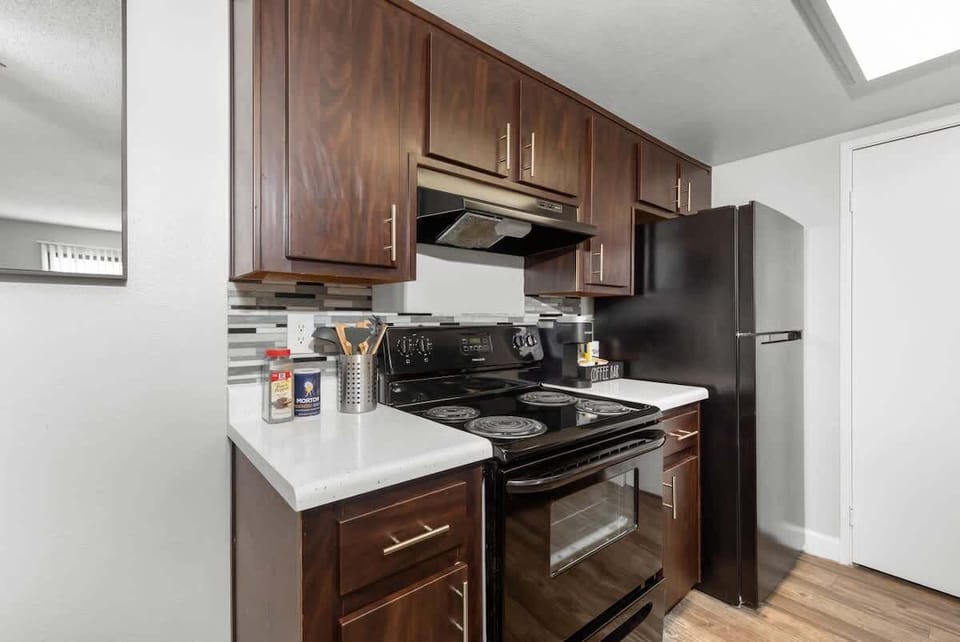 Functional kitchen with oven, stove, fridge and basic cooking ware