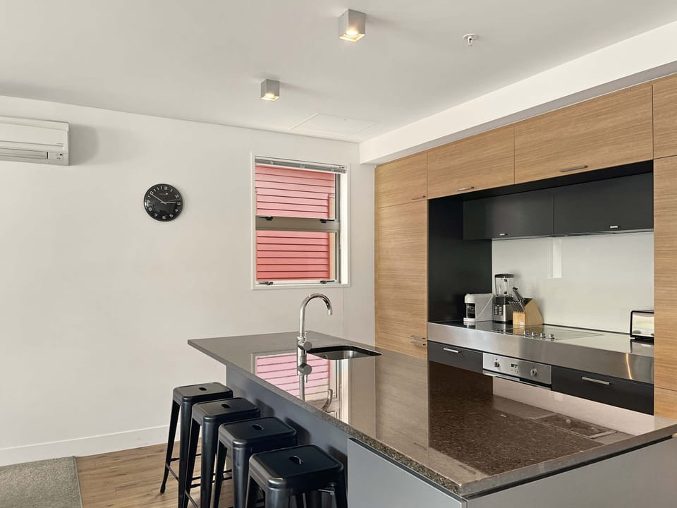 Sleek kitchen with breakfast bar seating