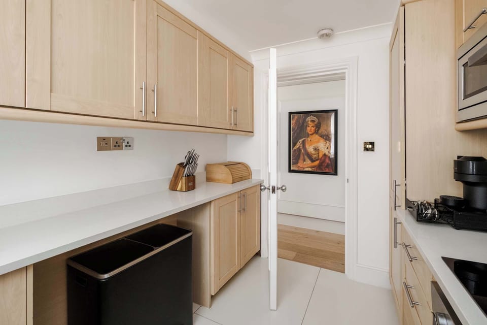 A fully equipped kitchen featuring a fridge freezer, Nespresso machine with pods, and a full selection of champagne, wine and martini glasses, washing machine, dryer and dishwasher for ultimate convenience.