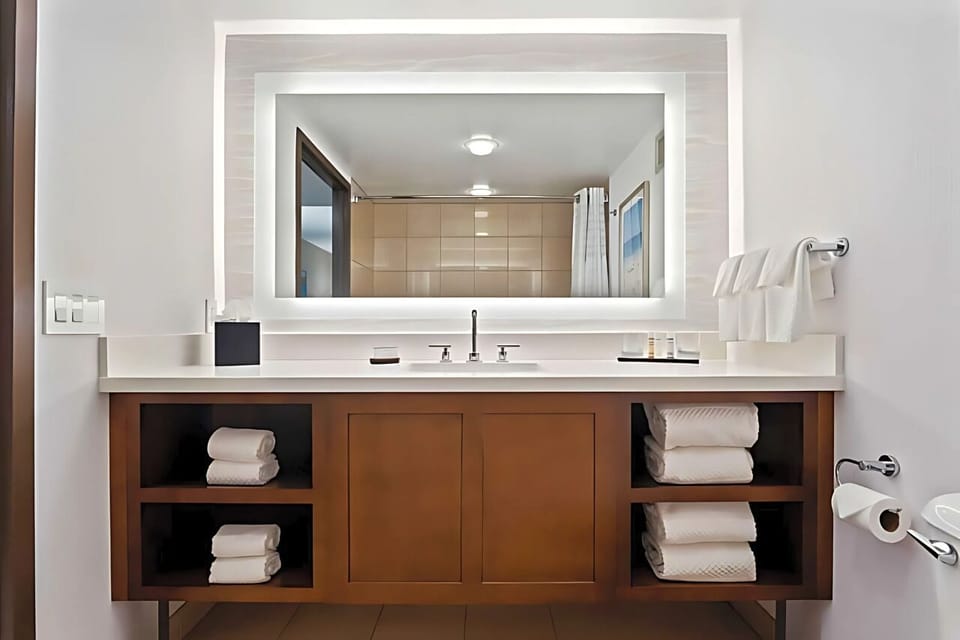 Refresh at a spotless vanity with plush towels within reach.