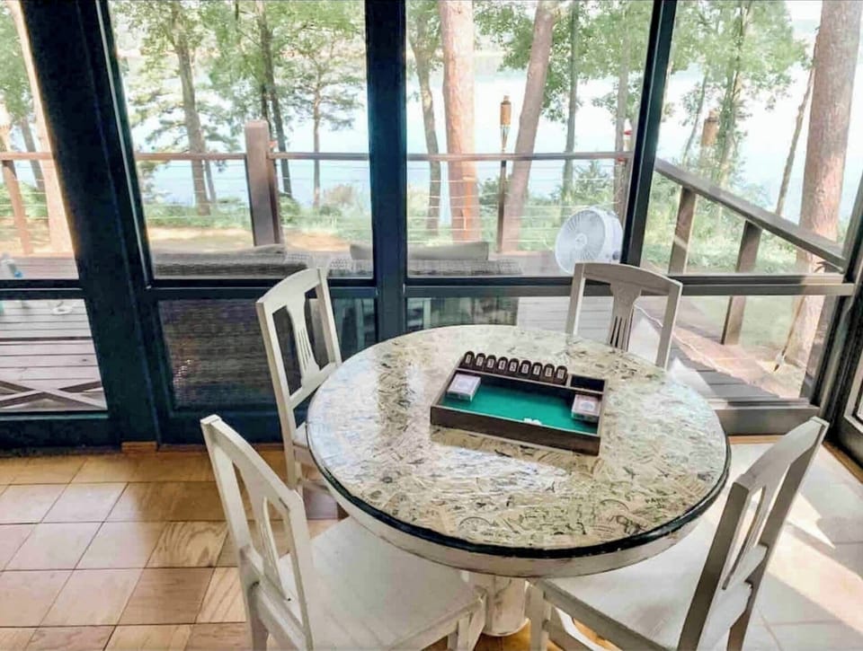 Sunporch game table. Window ac unit cools in summer and heats in winter