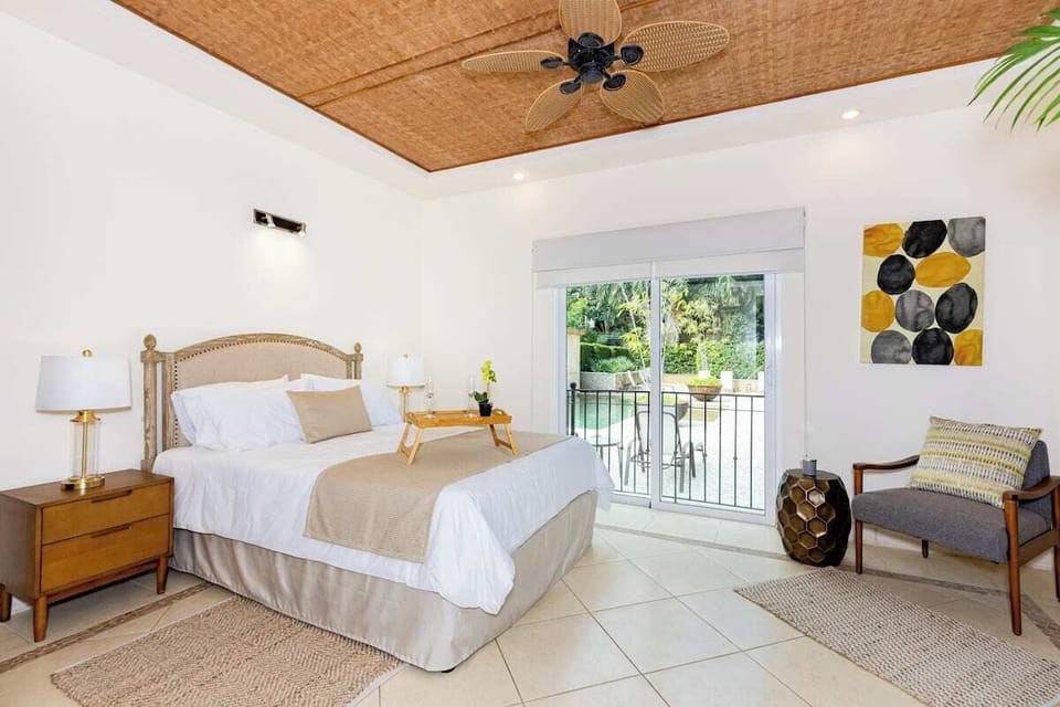 Bedroom 1 with pool view and queen bed.