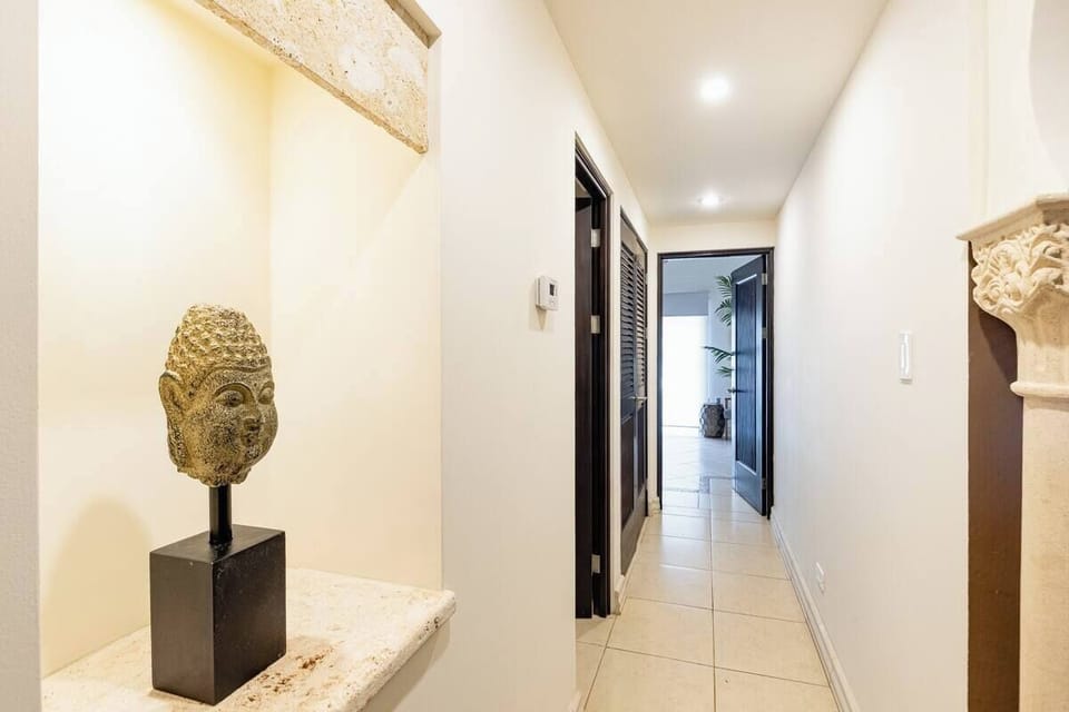 Hallway with the central air conditioning control.