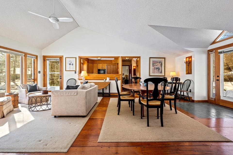 A bright, functional space! Living area, dining table, and an ocean view.
