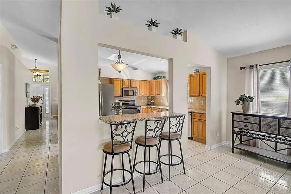 Bright kitchen with breakfast bar and garden views