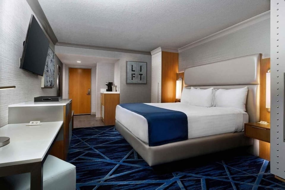 Relax in a bright king room with modern finishes and TV.