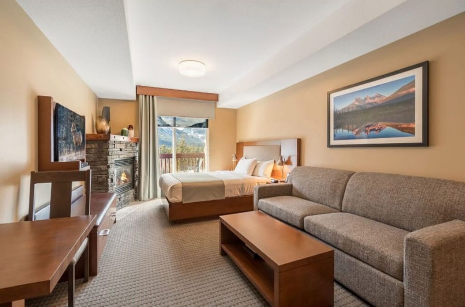 Spacious living area with cozy seating and warm lighting, perfect for unwinding in comfort.