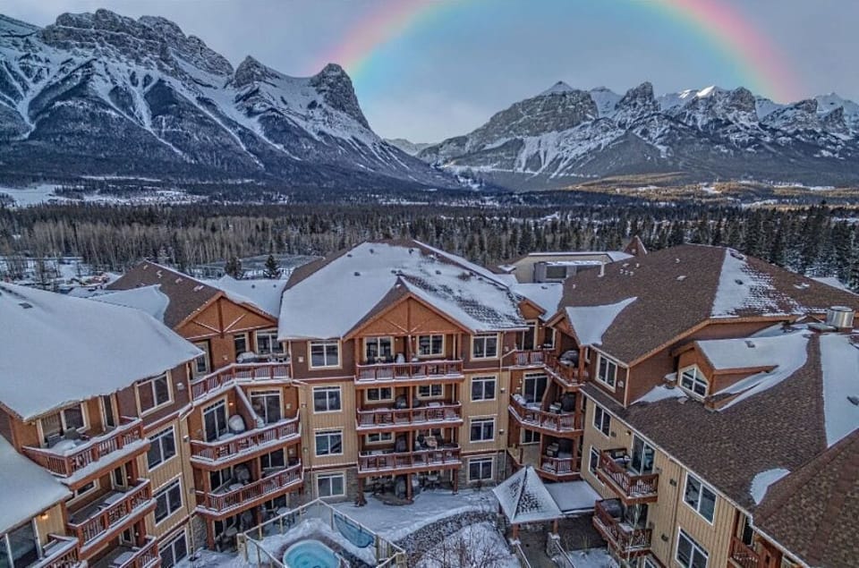 A winter wonderland escape awaits, with warm hospitality and panoramic views of Canmore’s majestic mountain landscape.