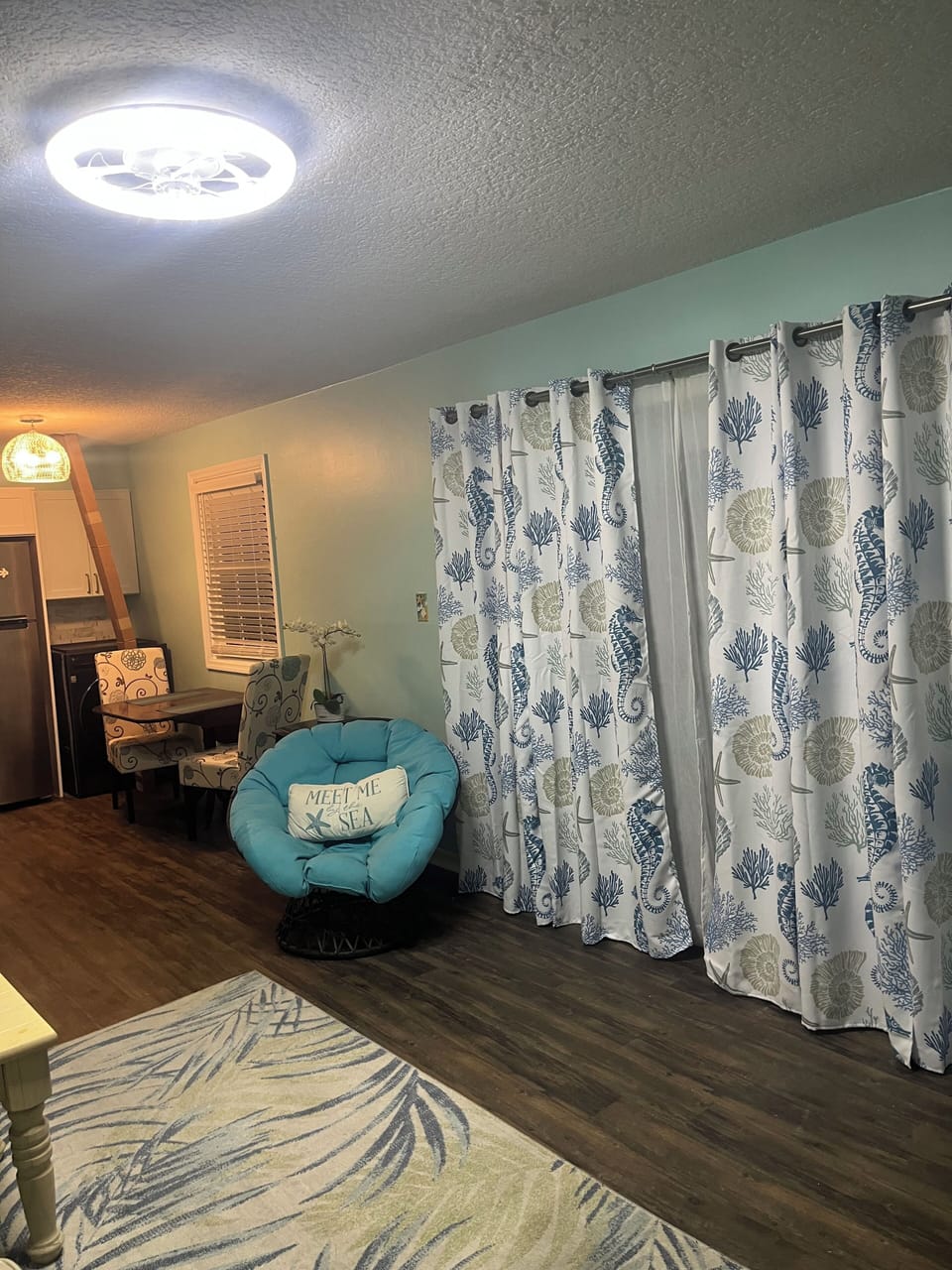 Living/ dining open with huge windows and door to huge brick fenced patio 