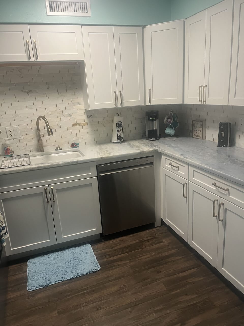 Beautiful new kitchen with gold fixtures and tile backsplash 