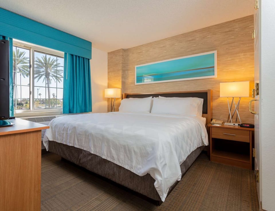 Unwind in a crisp king bed with sunny views.