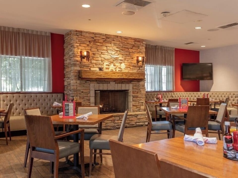 Savor cozy meals by the glowing stone fireplace lounge.