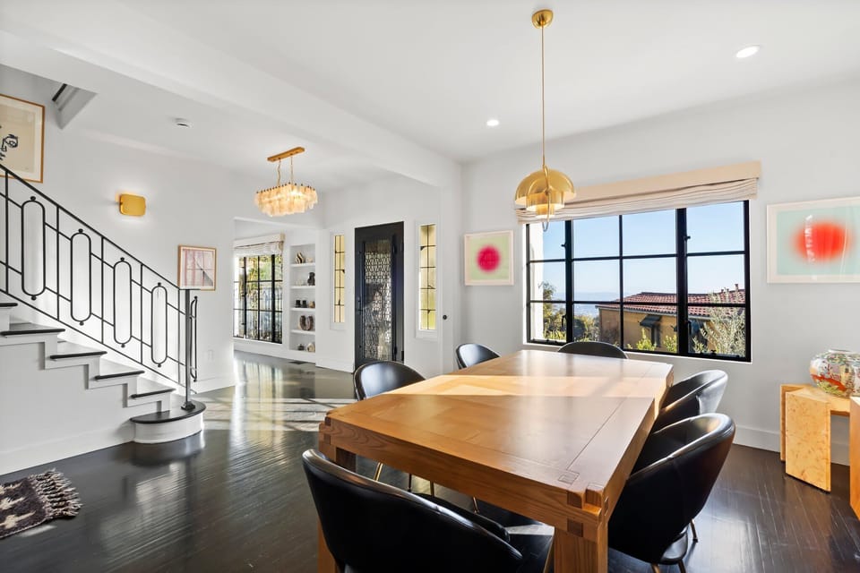 Dine in style with designer pendant lights and expansive outdoor views.
