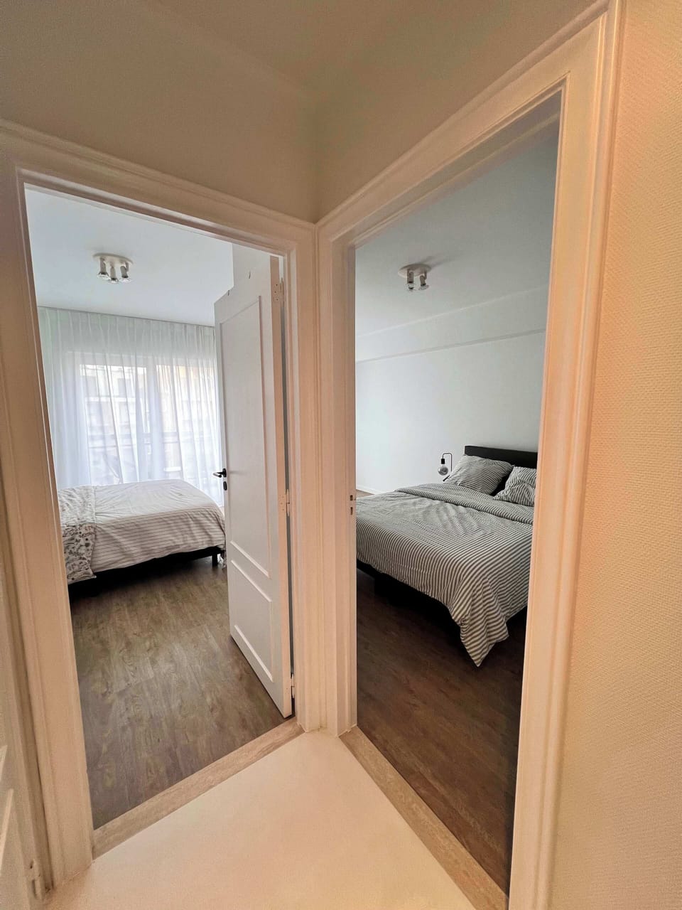 Hallway connecting both bedrooms with natural flow
