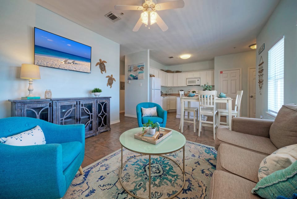 Coastal-inspired décor, plush seating, and a sleeper sofa in the living room.