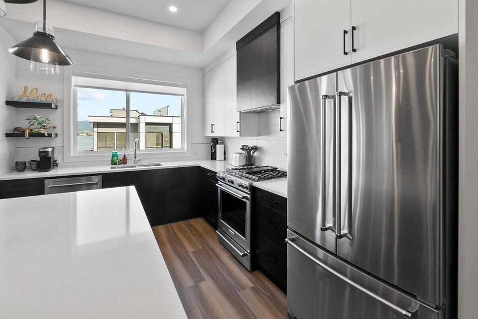 Modern kitchen with dark cabinetry and stainless steel appliances, designed for both style and functionality.