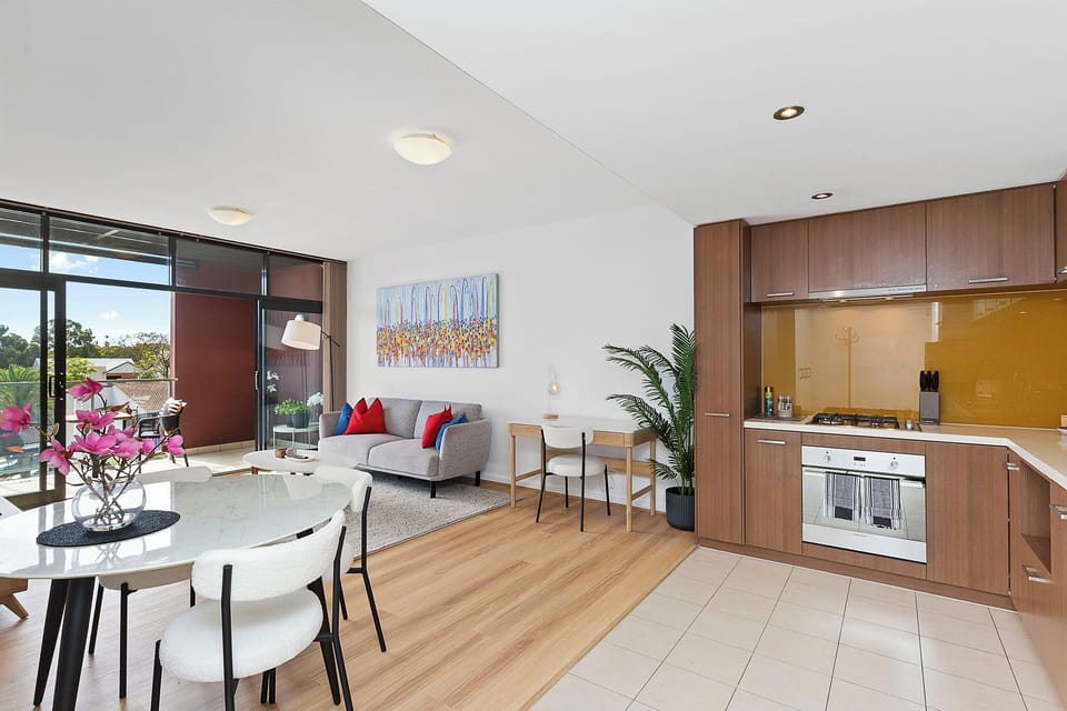 Experience elegance in this open-plan living area, with a view of the stylish, well-equipped kitchen.