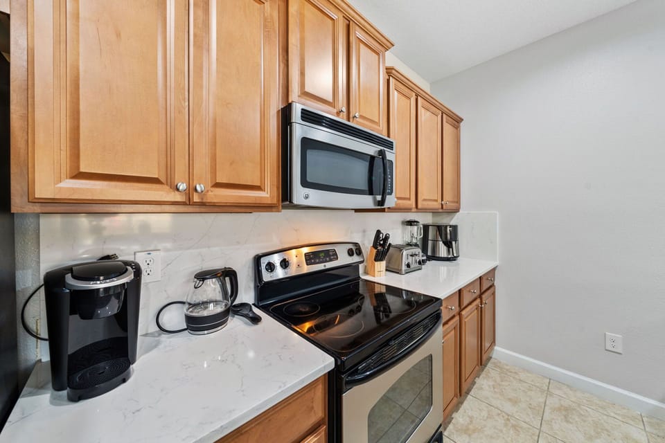 Cook your favorite meals with ease in a kitchen featuring stainless-steel appliances and sleek countertops
