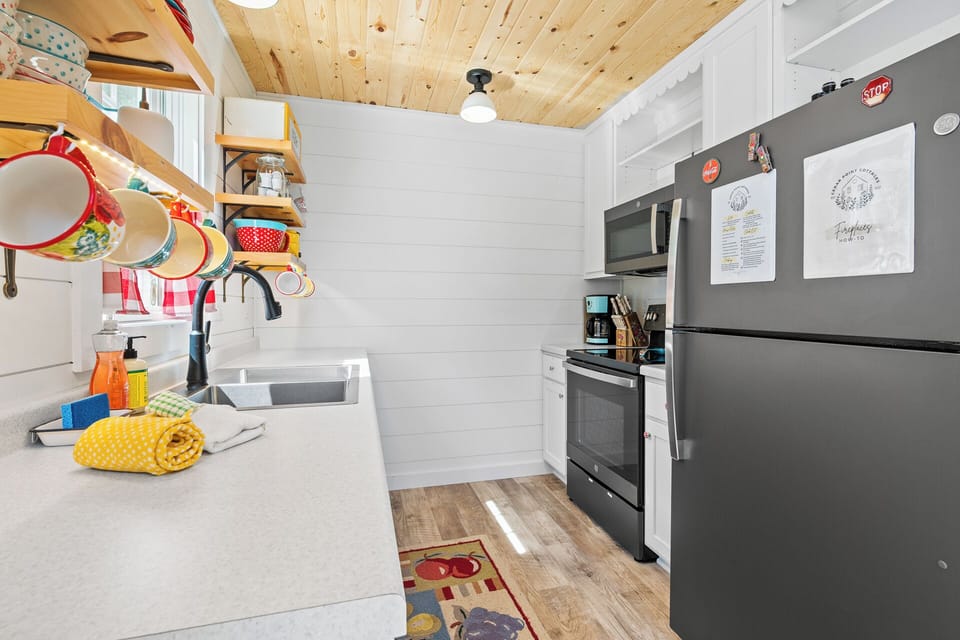 blue cottage galley kitchen w/ everything you could need to enjoy meals together
