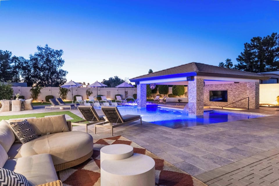 Resort-Style Pool & Cabana – Relax by the sparkling pool with waterfalls, shaded cabana, outdoor TV, and plenty of lounge seating.