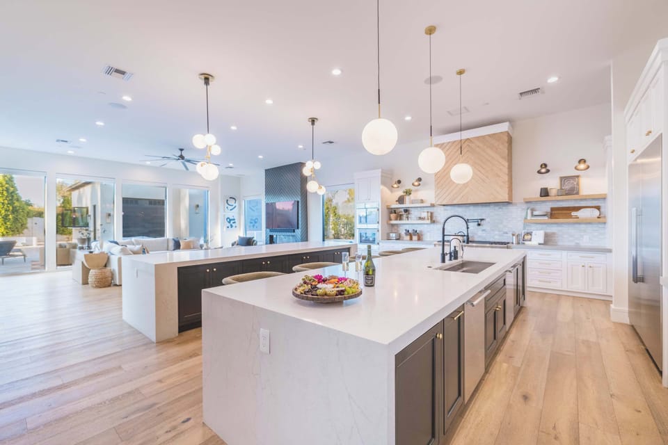 Gourmet Kitchen – Bright, open kitchen with quartz counters, dual islands, modern lighting, and high-end appliances. Perfect for entertaining or family meals.