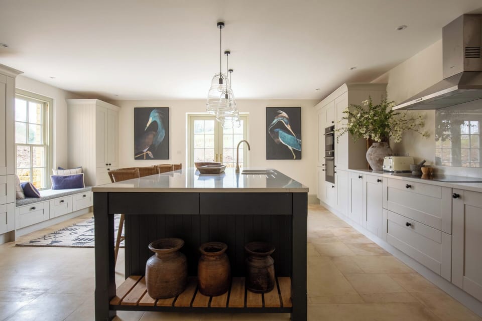 View from the utility room door across the kitchen breakfast bar 