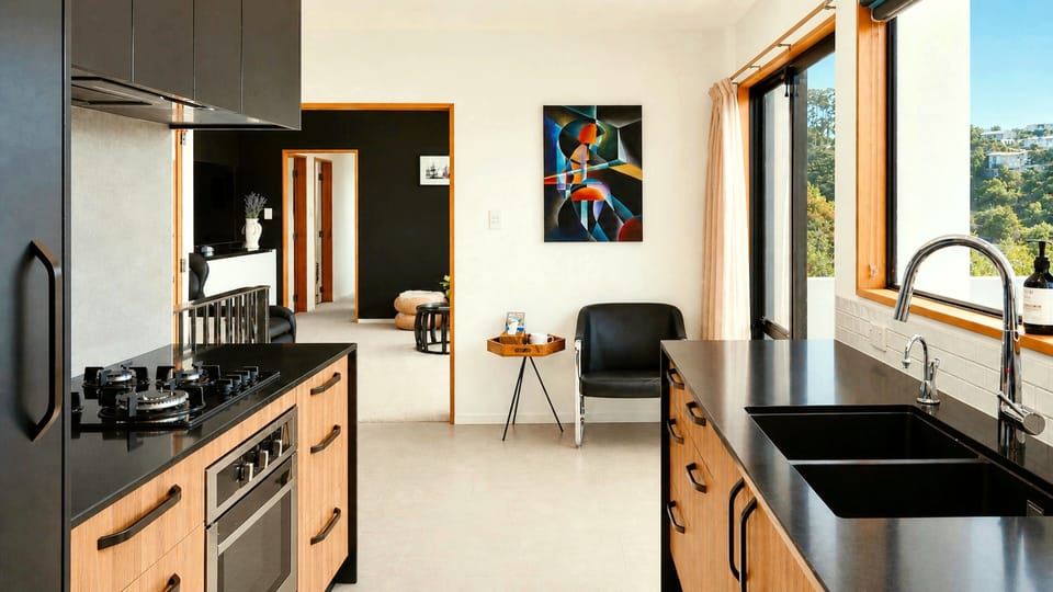 Open-plan kitchen and lounge with original artwork hand-painted by your host
