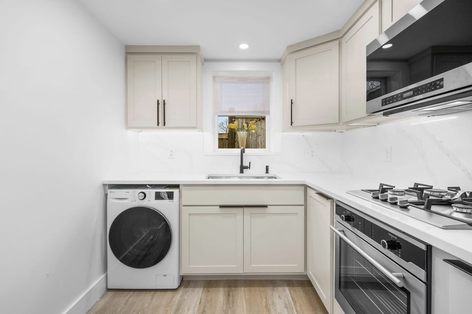 Gas stove and built in oven complete the clean cashmere kitchen