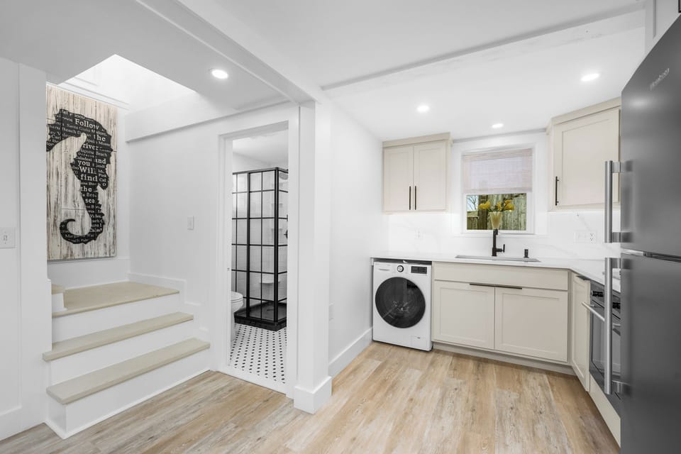Bath and stairs leading up to two bedrooms