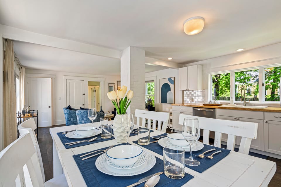 Bright dining area with navy accents and open to a sunny kitchen.