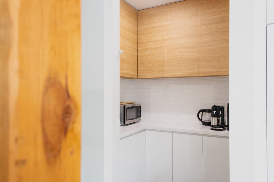 Compact kitchen area with essential appliances and storage