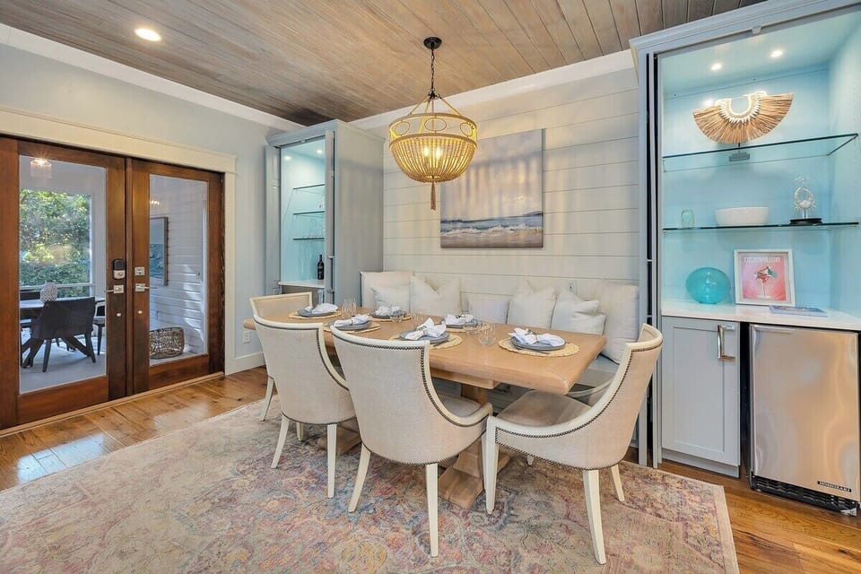 Dining area with gold pendant light and French doors