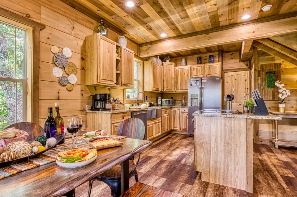 Prepare meals with ease in this cabin kitchen, steps away from the elegant dining room—perfect for seamless entertaining and cozy Gatlinburg family gatherings.
