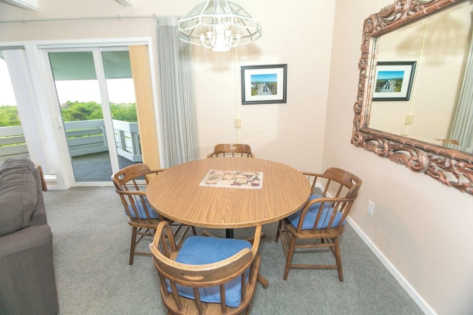 Share relaxed meals beside sliding doors and breezy light.