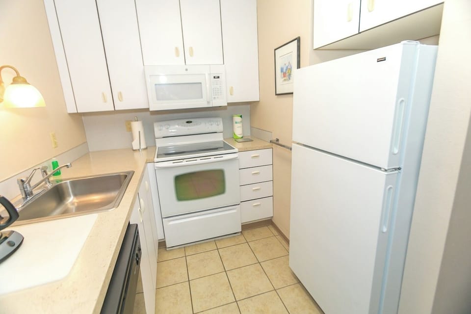 Cook comfortably with full-size fridge, microwave, and range.