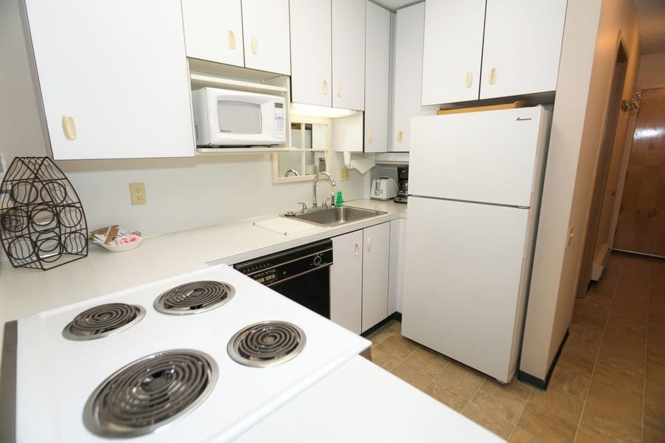 Cook simple favorites in the bright kitchen with full-size fridge.