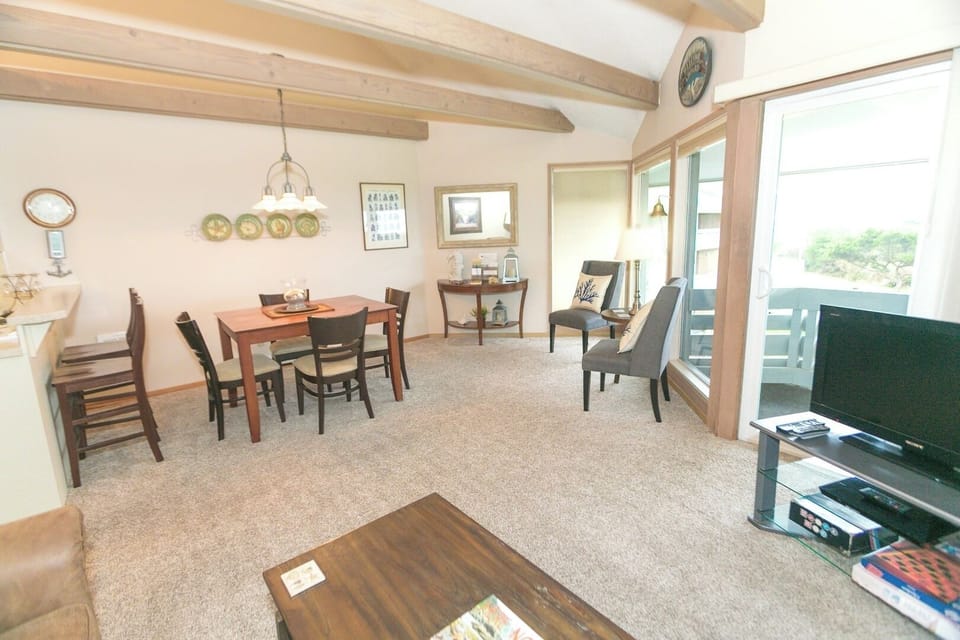 Breathe in the light-filled living room with scenic balcony views.