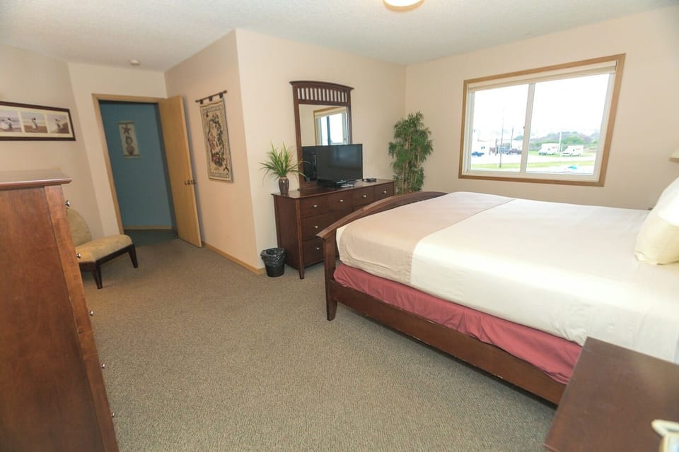 Unwind in a spacious king bedroom with bright morning light.