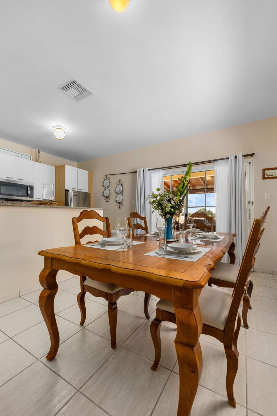 Savor delightful meals in this inviting dining area, featuring a charming table and beautiful views for a memorable experience!