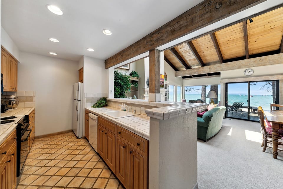 Your open kitchen flows seamlessly into the living space, where exposed beams and breathtaking sea views create the perfect backdrop for your getaway.