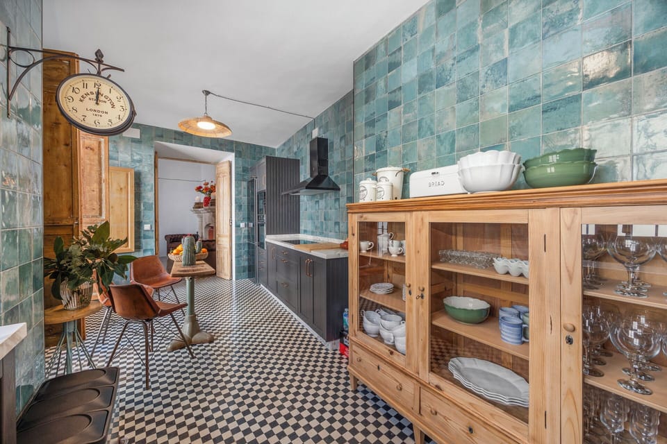 The kitchen with original tiles leads onto the courtyard and into the dining roo