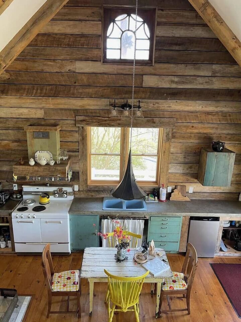 The kitchen light fixture is a reclaimed Victrola horn, a nod to the family buisness: music history