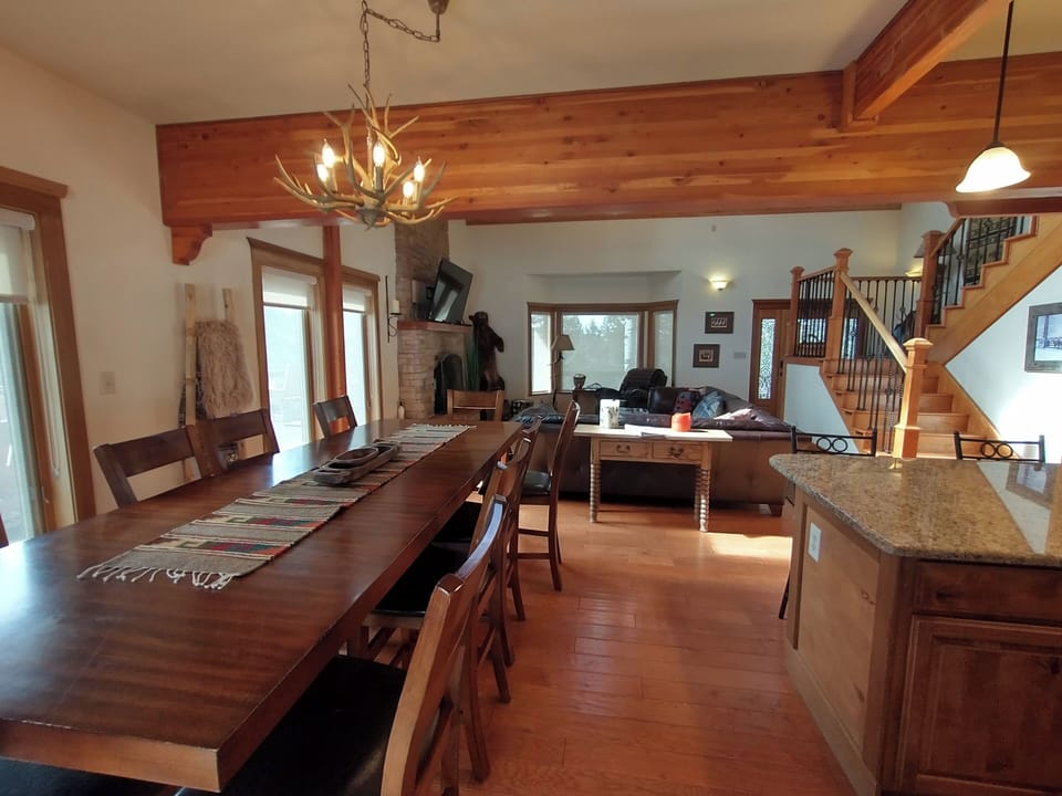 A large dining area with ample seating for 10 and 5 bars stools on the island.