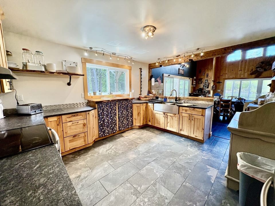 Fully equipped kitchen with a farmhouse sink and charming wood details.
