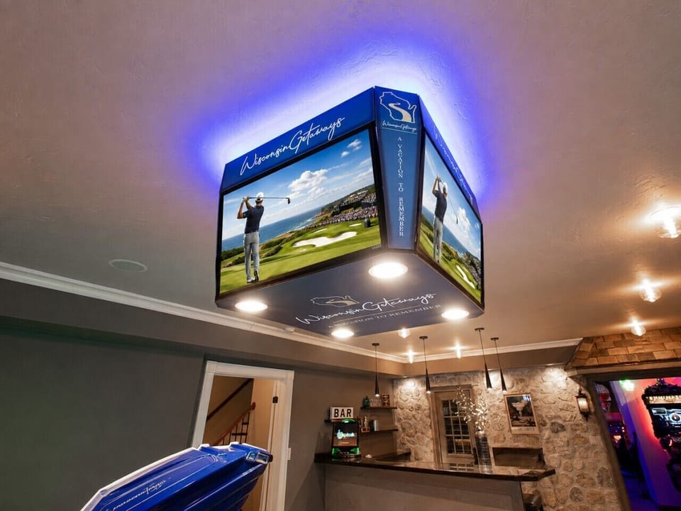 A four-screen sports display lets guests follow the action from different areas of the entertainment level.
