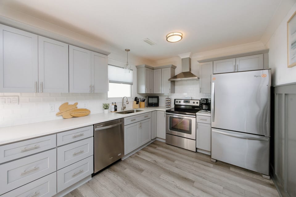 Fully equipped kitchen with modern appliances, cooking essentials, spices