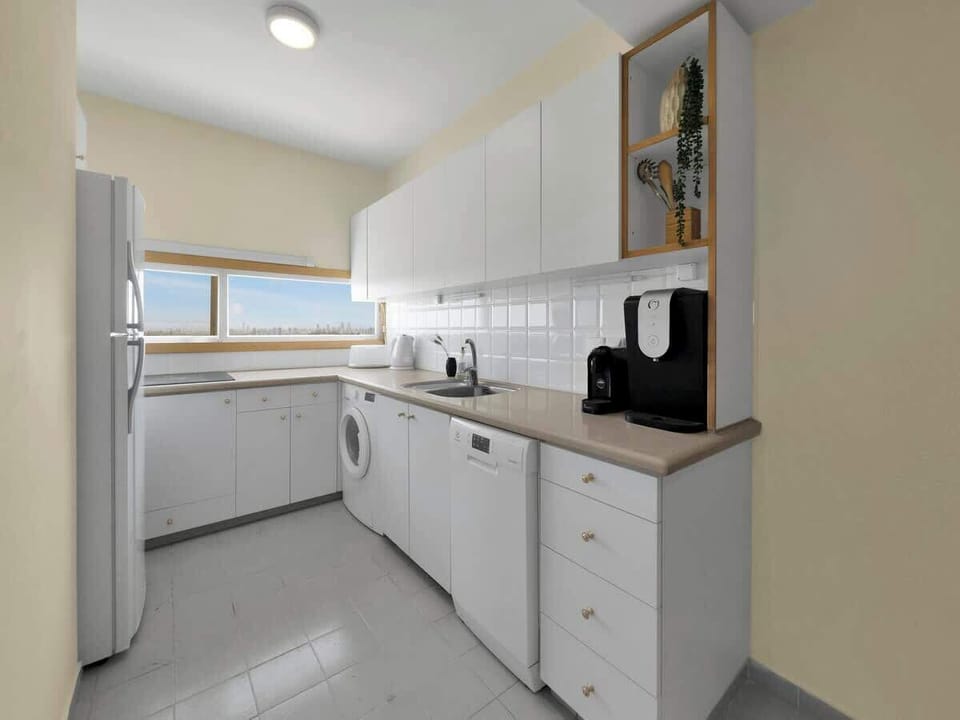 A functional kitchen space with the added ease of a washer for longer, stress-free stays.
