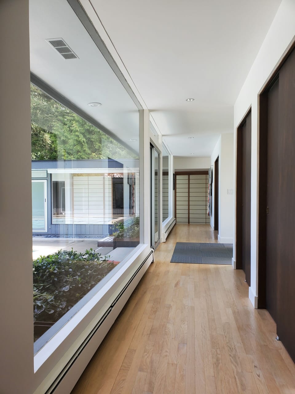 Bright interior with large floor to ceiling windows looking to the courtyard.