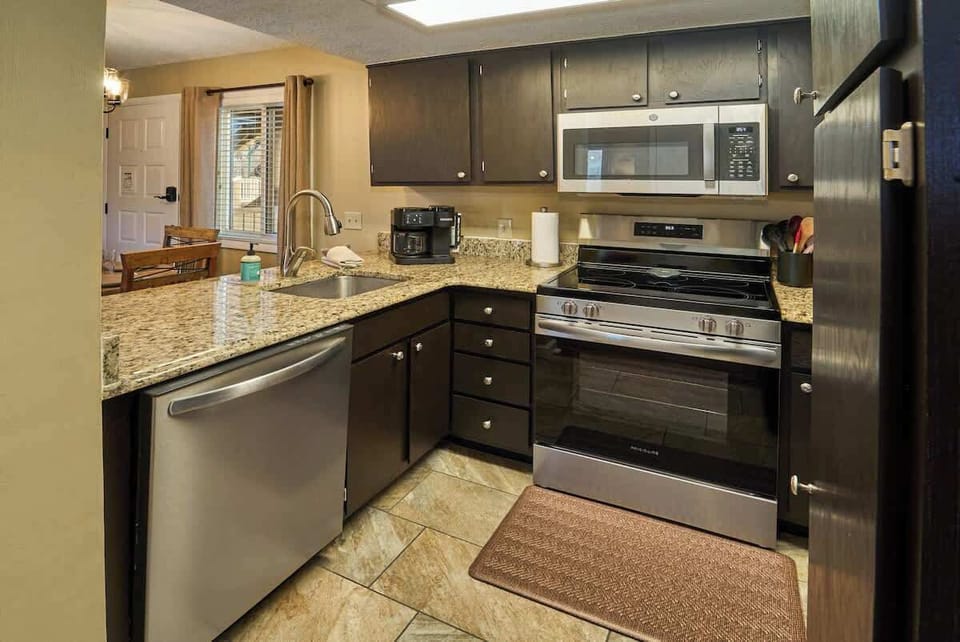 The well stocked, updated kitchen features granite countertops and stainless steel appliances making dining in a pleasant option.